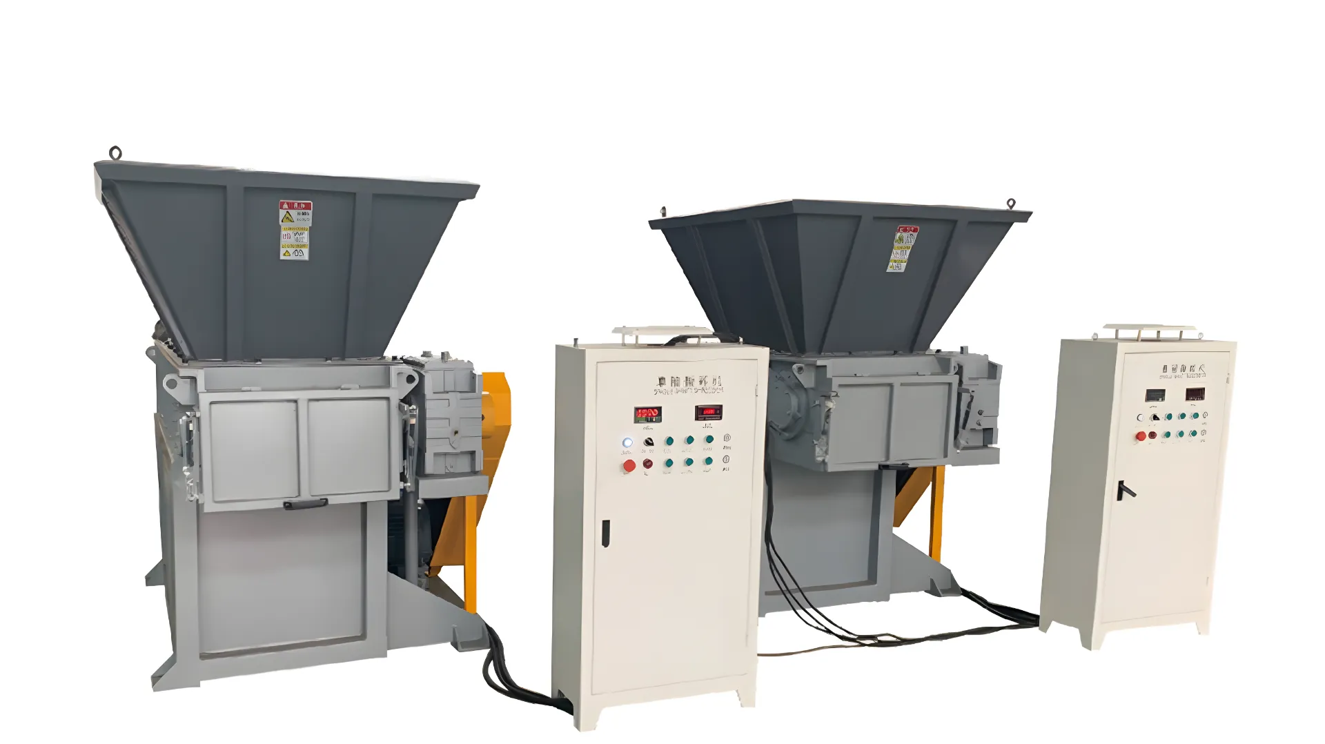 This image features two fixed bucket single shaft shredders. Each shredder unit includes a large hopper for material input, a shredding mechanism visible at the base, and an attached electrical control panel with various buttons and indicators. The equipment is designed for industrial use, capable of breaking down materials into smaller pieces for processing or recycling. The machinery is robust, with a gray and yellow color scheme, highlighting the industrial strength and purpose of the shredders.