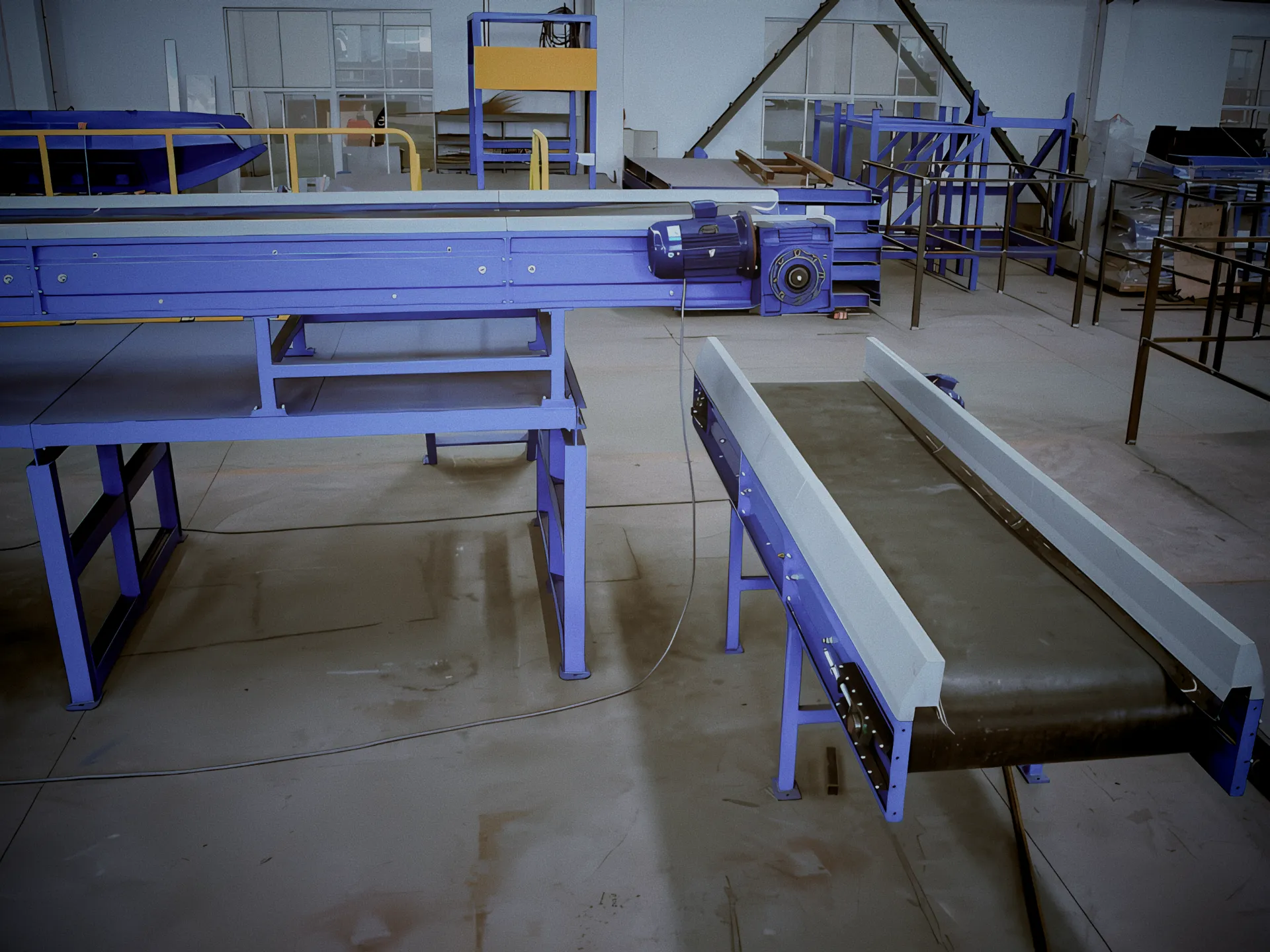 Industrial conveyor belts in a manufacturing facility for material handling.