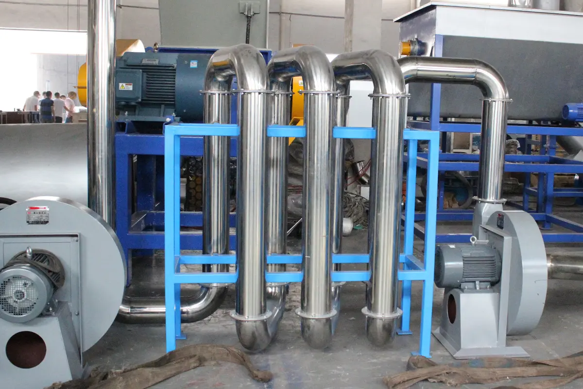 a thermal drying machine, which is part of an industrial system designed to dry materials by using heat. The setup includes a series of metal pipes and cylinders, likely for the conveyance of materials and hot air. Several motors and mechanical components visible in the image suggest that this system operates with a combination of heat and mechanical movement to achieve efficient drying. The use of stainless steel and the robust structure indicate it's built for durability and high performance in industrial settings.